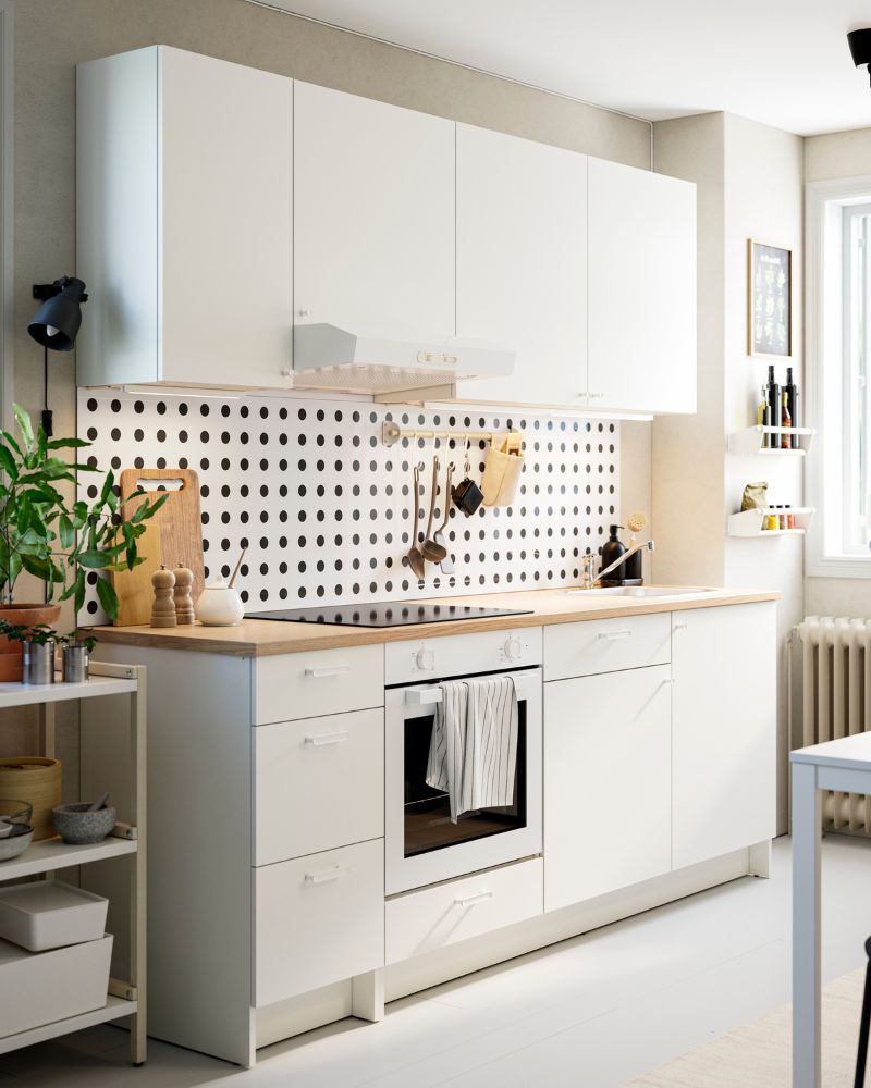 A small parallel kitchen features white KNOXHULT base and wall cabinets and LAGAN appliances.