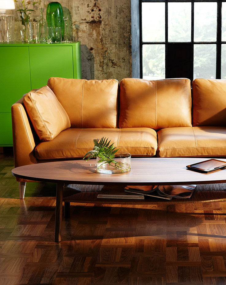 A modular living room set with decorative accents and details in light tones. 